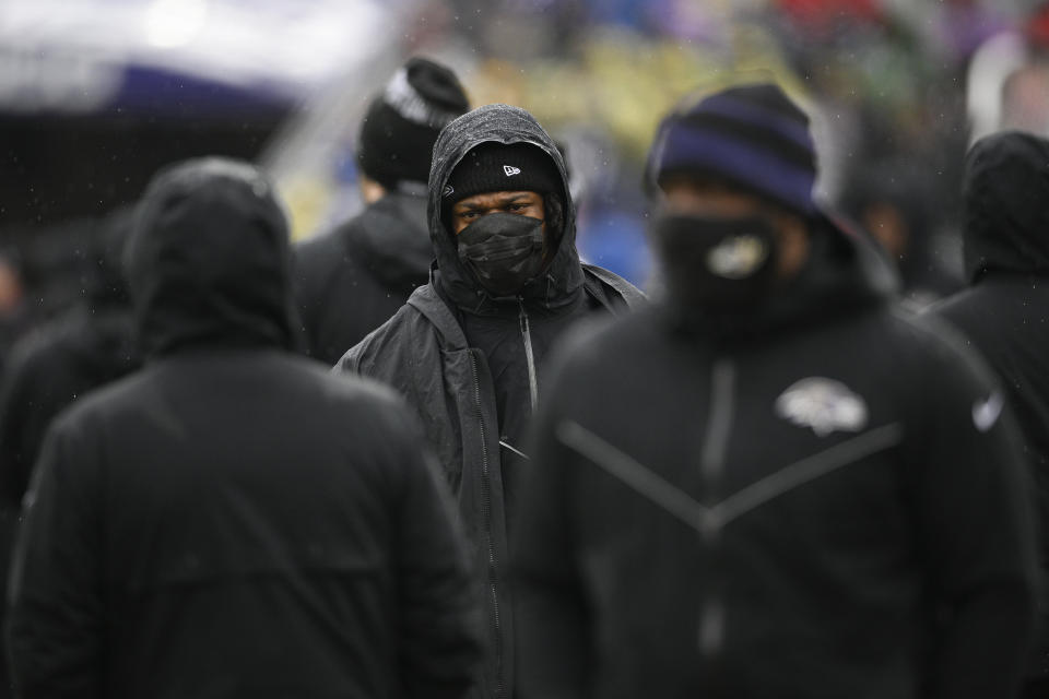 Baltimore Ravens quarterback Lamar Jackson, center, walks on the sideline during the first half of an NFL football game against the Pittsburgh Steelers, Sunday, Jan. 9, 2022, in Baltimore. (AP Photo/Nick Wass)