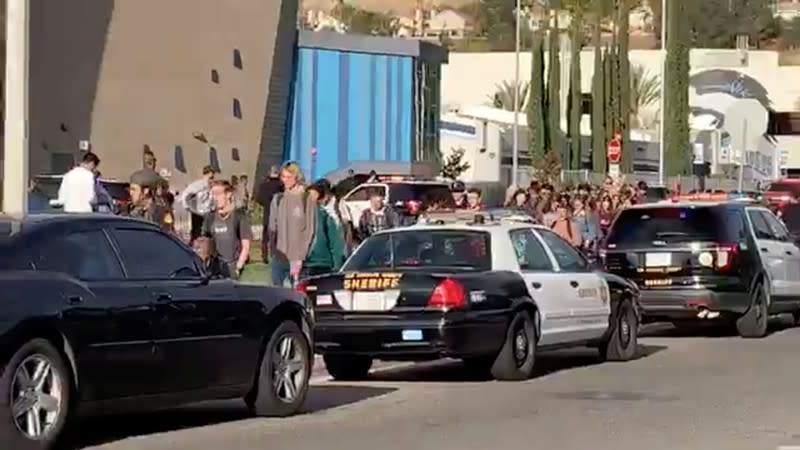 Sheriffs escort students and faculty out of Saugus High School in Santa Clarita, California