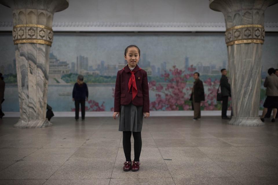 Student Jo Chong-A, 10, poses for a portrait in a subway station of the Pyongyang metro.