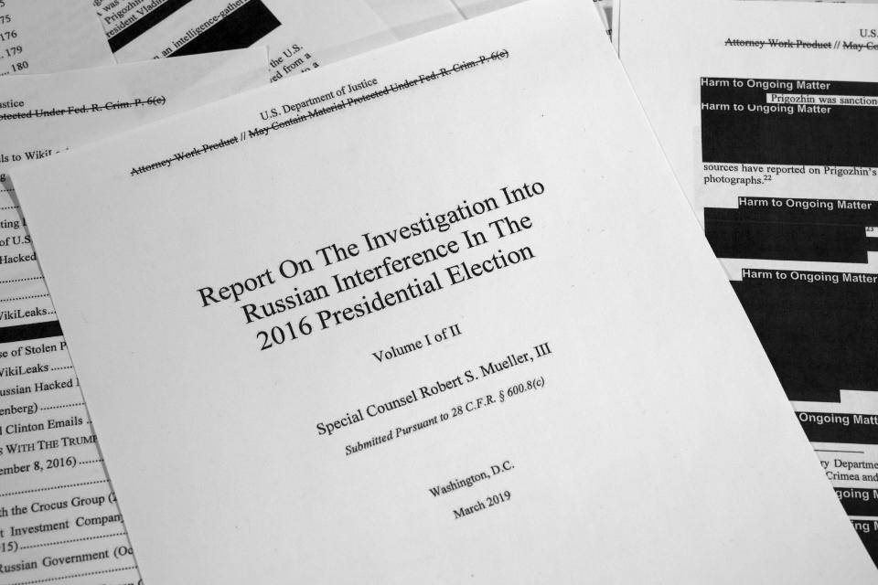 FILE - This Thursday, April 18, 2019 file photo shows special counsel Robert Mueller's redacted report on Russian interference in the 2016 presidential election as released in Washington. An Associated Press review shows the idea of Ukrainian interference took root during Donald Trump’s 2016 presidential campaign, was spread online and then amplified by Putin before some of America’s elected officials made it their truth. (AP Photo/Jon Elswick)