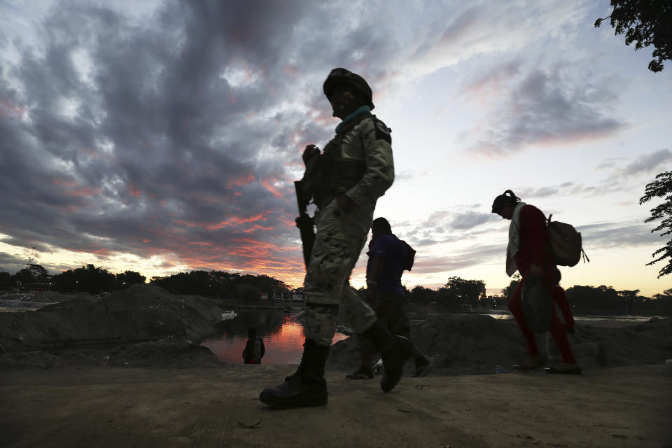 A Mexican National Guard patrols near the bridge that crosses the Suchiate River, on the border with Guatemala, near Ciudad Hidalgo, Mexico, Friday, Jan. 17, 2020. United States officials are crediting tough measures taken over the past year and cooperation from regional governments for sharply reducing the number of Central American migrants who responded to a call for a new caravan. (AP Photo/Marco Ugarte)