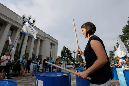 Halyna Yanchenko, head of the AntiCorruption Headquarter non-government organisation, calls for several Ukrainian lawmakers, suspected of corruption by the General Prosecutor's Office, to be stripped of parliamentary immunity during a rally near the parliament building in Kiev, Ukraine July 11, 2017. Picture taken July 11, 2017. REUTERS/Valentyn Ogirenko