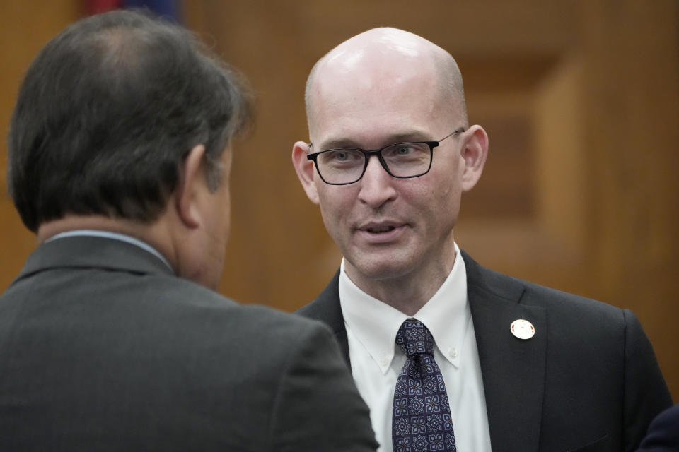Rex Shannon, an attorney with the Mississippi Attorney General's Office, speaks to a colleague prior to a hearing, Wednesday, May 10, 2023, in Hinds County Chancery Court in Jackson, Miss., where a judge heard arguments about a Mississippi law that would create a court system with judges who would be appointed rather than elected. (AP Photo/Rogelio V. Solis)