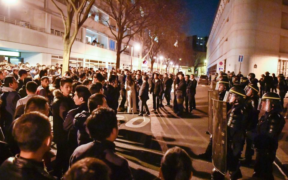 About 100 people from the Chinese community held a demonstration Monday evening in front of a police station in the 19th arrondissement of Paris - Credit: Rex Features