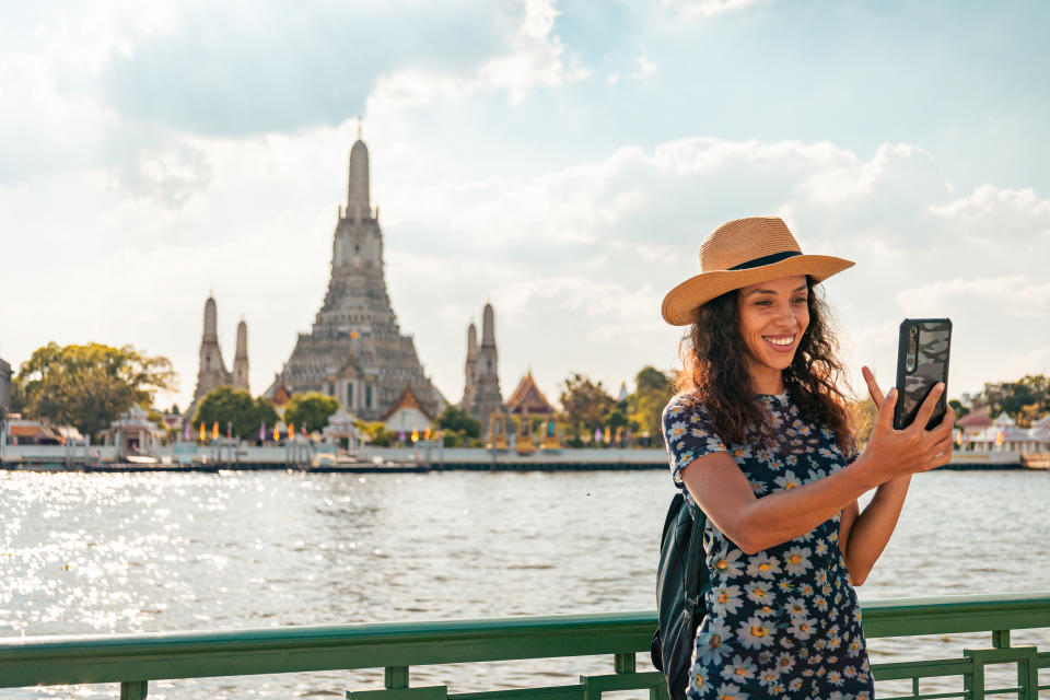 Tourist traveling at Wat Arun, Bangkok on her vacation (Getty Images)