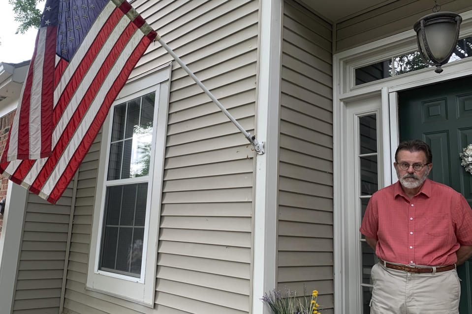 Richard Dayton stands in front of his house as he poses for a photograph, Friday, July 17, 2020, in Columbus, Ohio. State and local election officials across the country are trying to recruit younger workers to staff polling places on Election Day in November. The effort is driven by concern that many traditional poll workers will be too worried about catching the coronavirus to show up. (AP Photo/Farnoush Amiri)