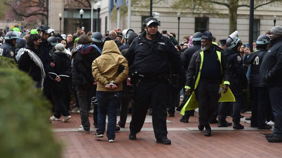 Police officers detain pro-Palestinian demonstrators who had set up an encampment on the South Lawn at Columbia University in New York, on Thursday afternoon. - C.S. Muncy/The New York Times/Redux