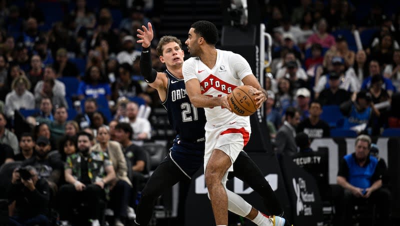 Toronto Raptors center Jontay Porter, right, is defended by Orlando Magic center Moritz Wagner (21) during game, Sunday, March 17, 2024, in Orlando, Fla.