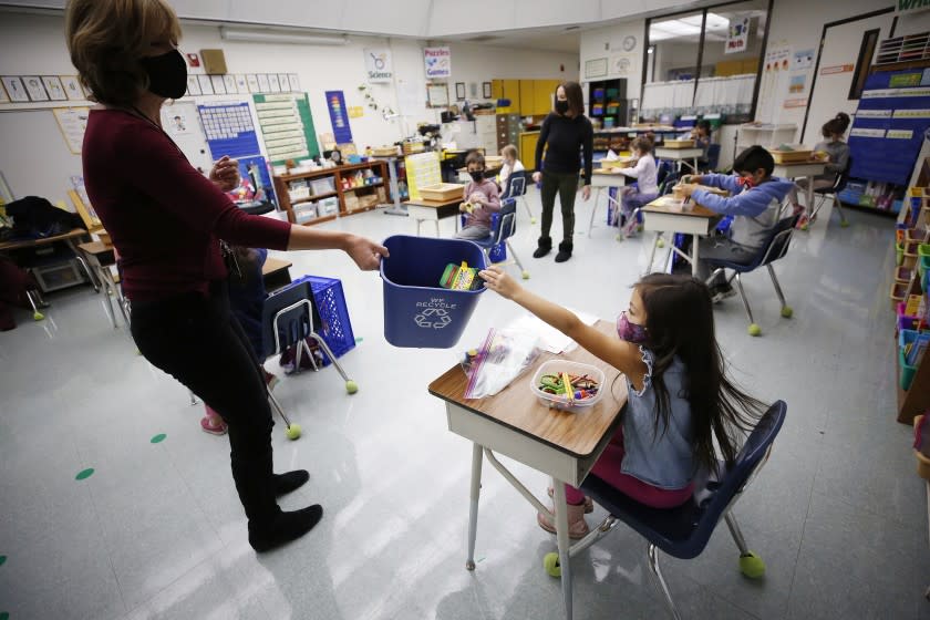 CALABASAS, CA - NOVEMBER 09: Kindergarten teacher Jennifer Klein collects crayons from students in the classroom at Lupine Hill Elementary School in Calabasas as one of the first elementary schools to open up under in L.A. County. This in the Las Virgenes Unified School District, which was the first public school system in Los Angeles county to win waiver approvals. Lupine Hill Elementary School on Monday, Nov. 9, 2020 in Calabasas, CA. (Al Seib / Los Angeles Times