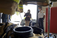 First lady Melania Trump talks with Chief Daniel Goonan as she visits the Manchester Fire Department Central Station, Thursday, Sept. 17, 2020, in Manchester, N.H. (AP Photo/Mary Schwalm)