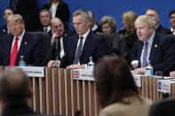U.S. President Donald Trump, left, and NATO Secretary General Jens Stoltenberg, center, listen to British Prime Minister Boris Johnson, right, during a NATO round table meeting at The Grove hotel and resort in Watford, Hertfordshire, England, Wednesday, Dec. 4, 2019. As NATO leaders meet and show that the world's biggest security alliance is adapting to modern threats, NATO Secretary-General Jens Stoltenberg is refusing to concede that the future of the 29-member alliance is under a cloud. (AP Photo/Frank Augstein)