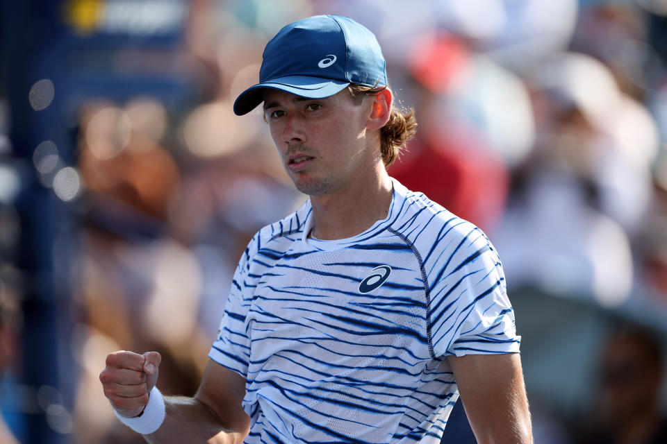 Alex de Minaur celebrates a victory.