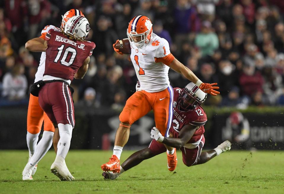 Clemson running back Will Shipley (1) runs  by South Carolina safety Jaylan Foster (12) during the second quarter at Williams Brice Stadium in Columbia, South Carolina Saturday, November 27, 2021.