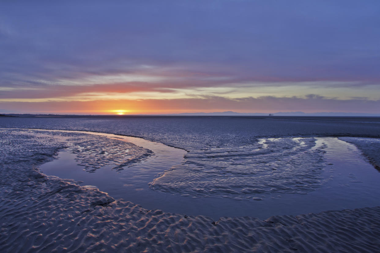 Sun rising over mudflats