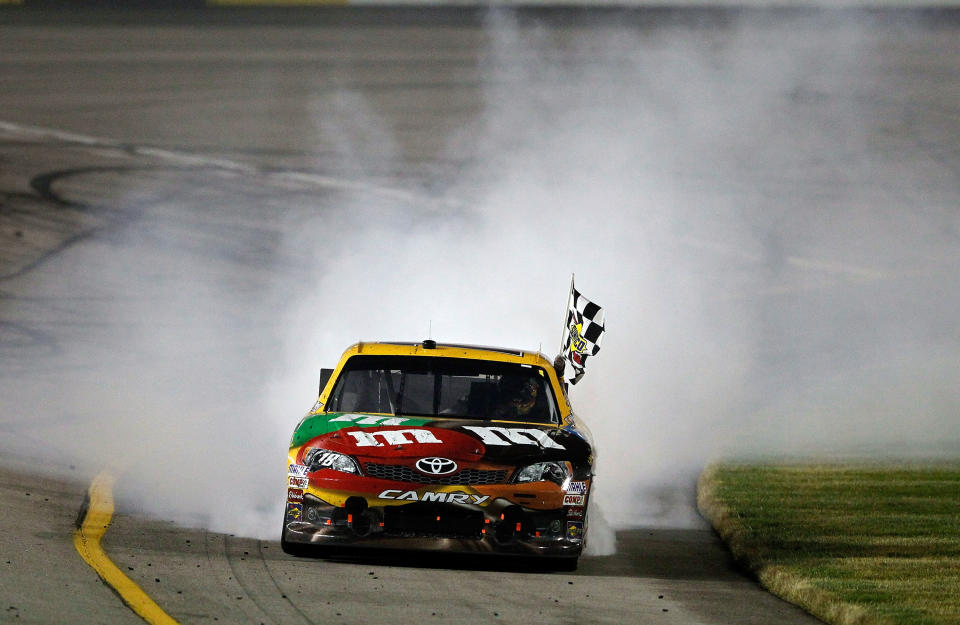 RICHMOND, VA - APRIL 28: Kyle Busch, driver of the #18 M&M's Ms. Brown Toyota, celebrates with a burnout and the checkered flag after winning the NASCAR Sprint Cup Series Capital City 400 at Richmond International Raceway on April 28, 2012 in Richmond, Virginia. (Photo by Streeter Lecka/Getty Images)