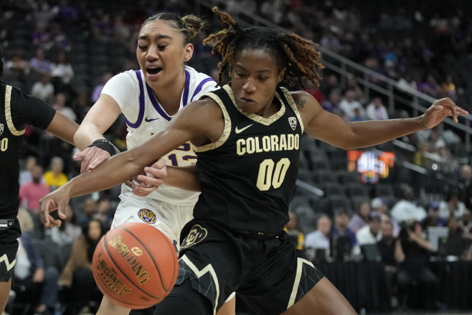 LSU guard Last-Tear Poa, left, and Colorado guard Jaylyn Sherrod (0) battle for the ball during the first half of an NCAA college basketball game Monday, Nov. 6, 2023, in Las Vegas. (AP Photo/John Locher)