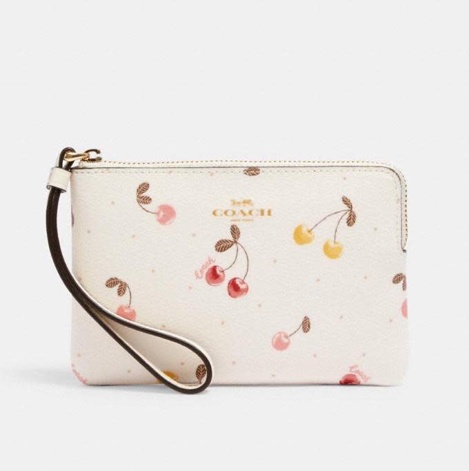 Corner Zip Wristlet With Painted Cherry Print. Image via Coach Outlet.