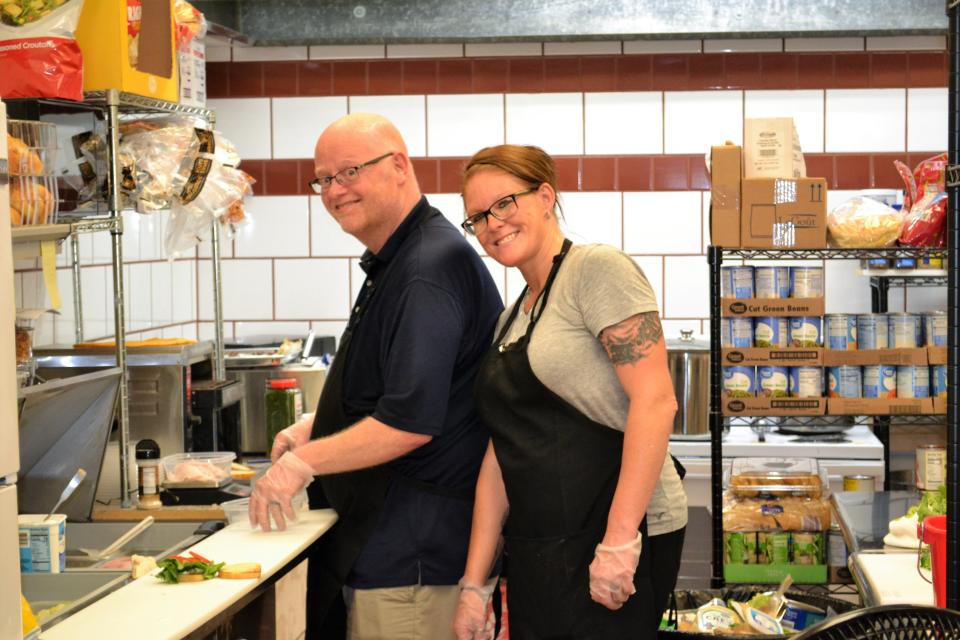 Shane Haley, left, and Kristina Hornaday working in the kitchen of Peddler's Loft Café, a new eatery on East Morgan Street in downtown Martinsville.