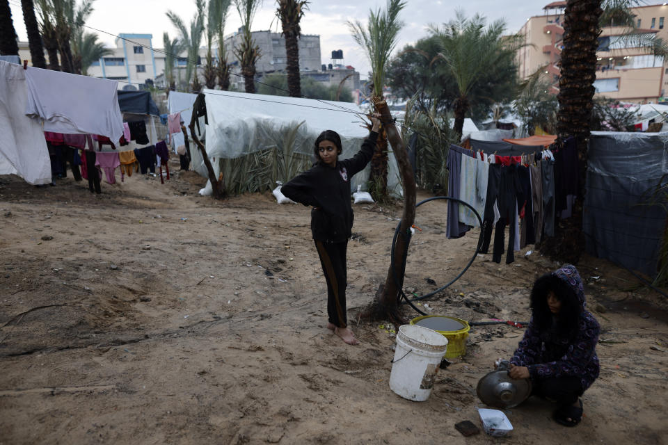 Palestinians displaced by the Israeli bombardment of the Gaza Strip are seen in tents in town of Khan Younis, Wednesday, Dec. 13, 2023. (AP Photo/Mohammed Dahman)