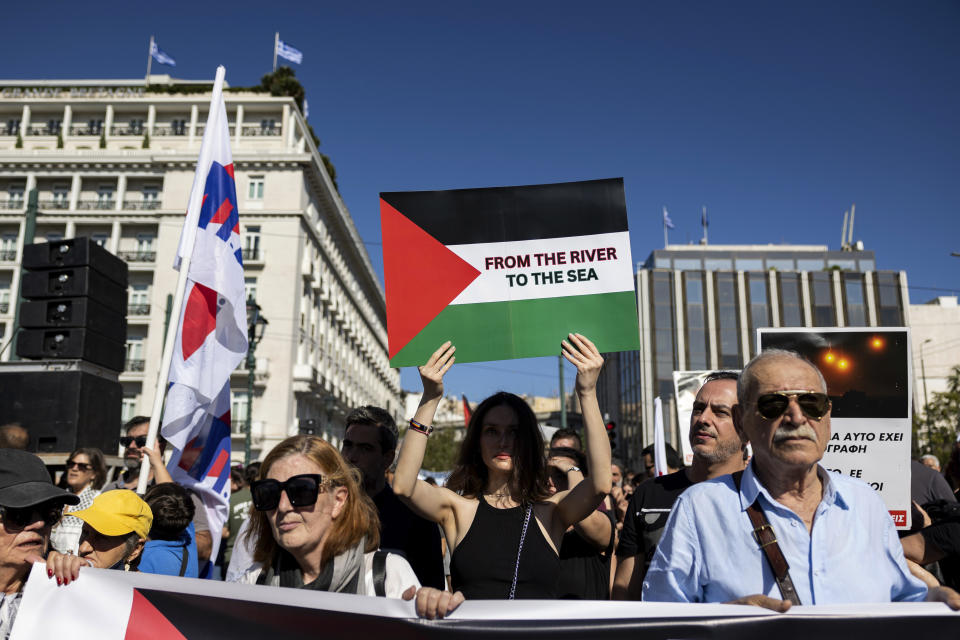 FILE - Pro-Palestinian protesters take part in a rally to express solidarity with Palestinians, in front of the parliament, in Athens, Greece, Sunday, Nov. 5, 2023. The Jordan River is a winding, 200-plus-mile run to the east of Israel and the West Bank. The sea is the glittering Mediterranean to its west. But a phrase about the space in-between, “from the river to the sea,” has become a battle cry with new power to roil Jews and pro-Palestinian activists in the aftermath of Hamas’ murderous rampage across southern Israel Oct. 7 and Israel’s bombardment of Gaza. (AP Photo/Yorgos Karahalis, File)