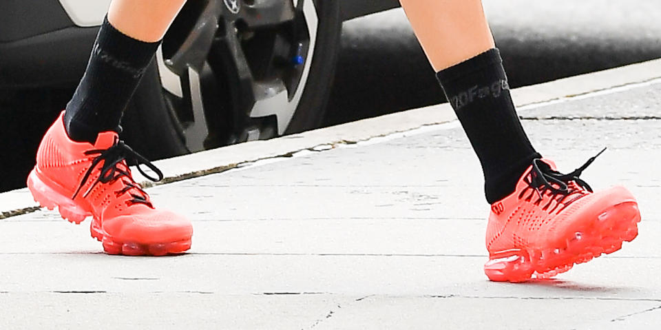 A closer look at Bella Hadid’s red sneakers. - Credit: Robert O' Neil / SplashNews.com