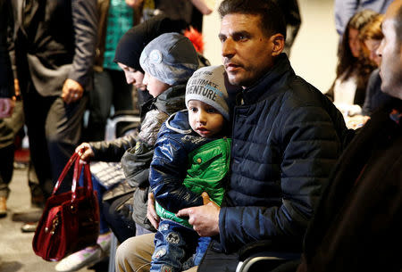 Unidentified people from Douma, Syria, arrive at a news conference in the Hague, Netherlands, April 26, 2018. REUTERS/Michael Kooren