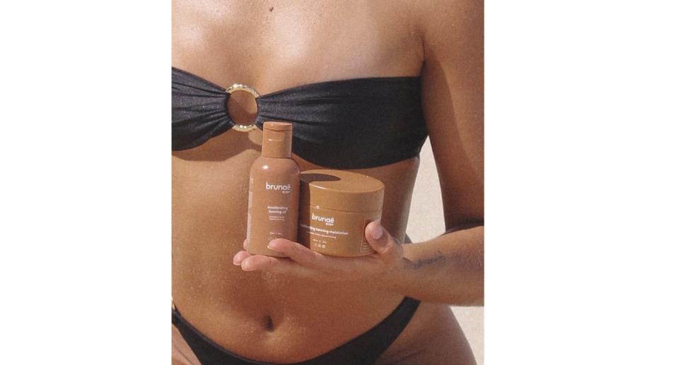 Woman holding Brunae Body products