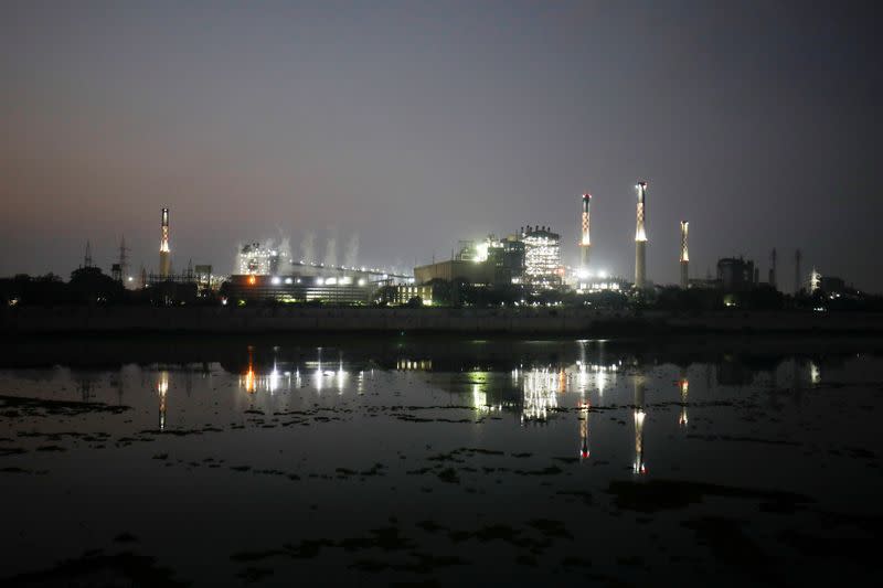 Smoke billows from the cooling towers of a coal-fired power plant in Ahmedabad