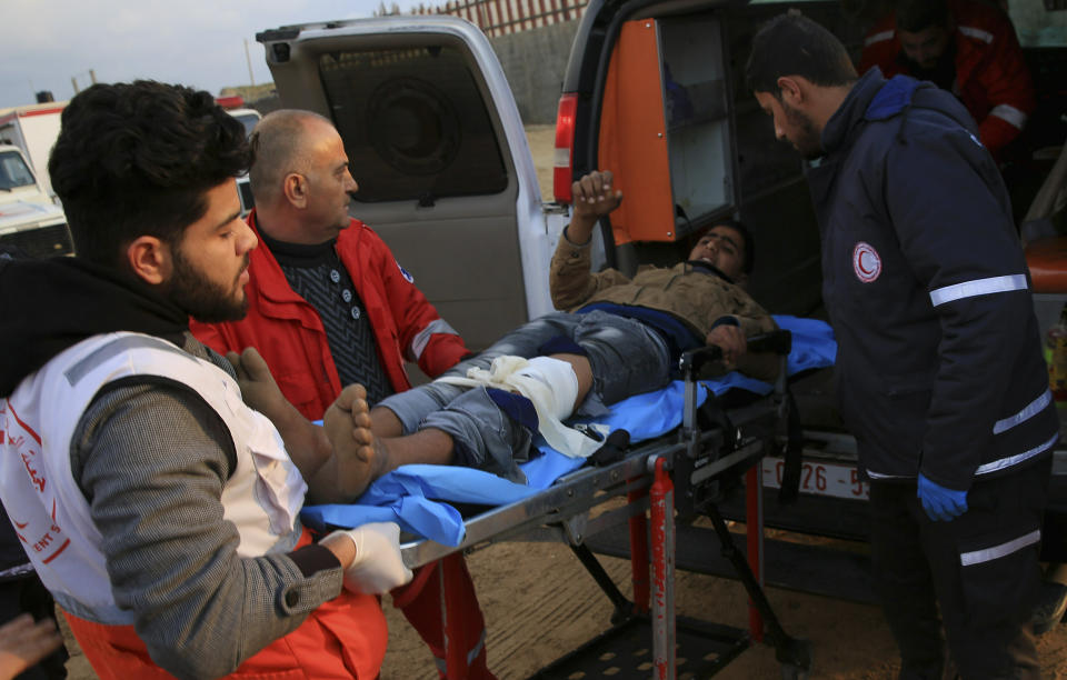 Medics move a wounded youth protester to the field clinic tent after he was shot during a protest near the fence of the Gaza Strip border with Israel, near Beit Lahiya, northern Gaza Strip, Tuesday, Feb. 19, 2019. (AP Photo/Adel Hana)