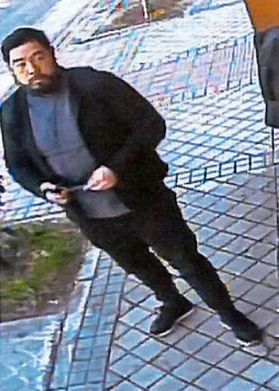 This Feb. 22, 2019 image from surveillance video at the North Korean Embassy to Spain in Madrid, contained in Department of Justice documents presented by federal prosecutors, shows U.S. Marine veteran Christopher Ahn as he prepares to enter the embassy. Ahn, suspected of involvement in a mysterious dissident group's February raid on North Korea's embassy, has been denied bond by a federal judge and must stay in custody. Ahn appeared in a Los Angeles courtroom on Tuesday, April 23. The charges against Ahn haven't been made public. (U.S. Department of Justice via AP)