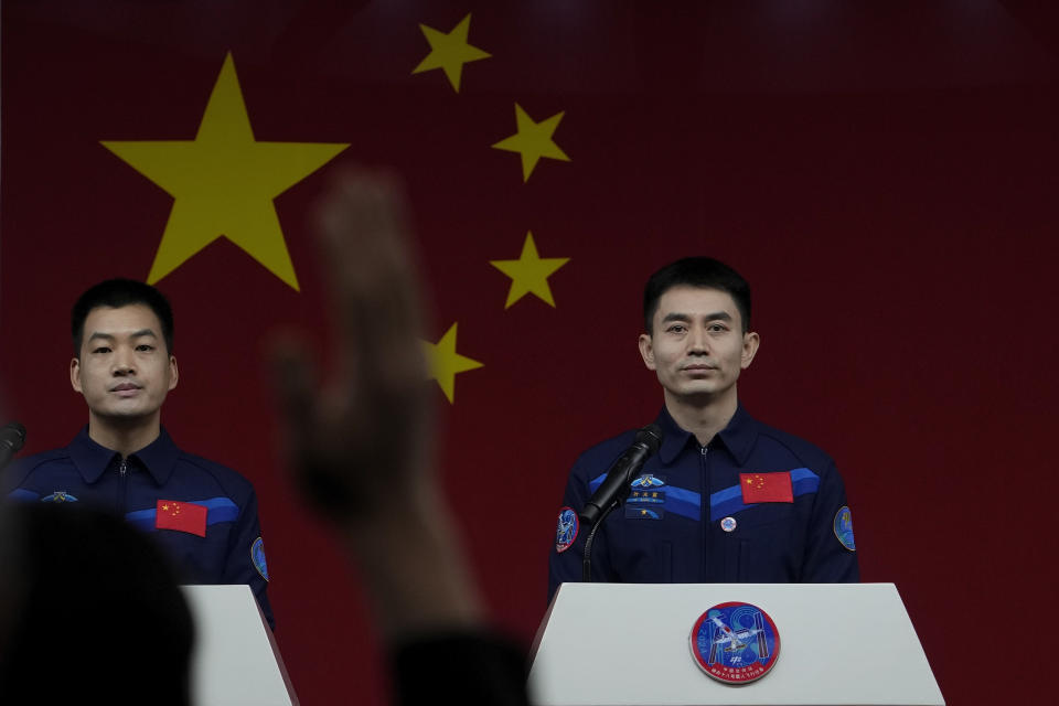 Chinese astronauts for the upcoming Shenzhou-18 mission, from right, Ye Guangfu and Li Guangsu watch as a reporter raises hand for a question during a meeting with media members at the Jiuquan Satellite Launch Center in northwest China, Wednesday, April 24, 2024. (AP Photo/Andy Wong)