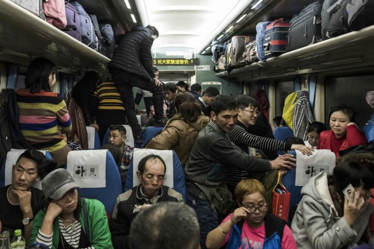 Passengers pack into a crowded train during the 26-hour journey from Beijing to Chengdu, as they head home ahead of the Lunar New Year