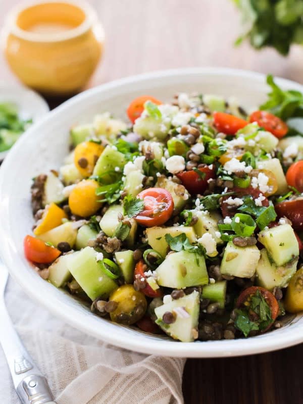<p>Kitchen Confidante</p><p>Make the most of heirloom tomatoes and cool, crunchy cucumbers in this summer lentil salad. It pairs beautifully with a flavorful roast chicken, grilled steak, simple fish —almost anything! And with hearty lentils, it is wonderful as a vegetarian main dish as well.</p><p><strong>Get the recipe: <a href="https://kitchenconfidante.com/summer-lentil-salad-recipe" rel="nofollow noopener" target="_blank" data-ylk="slk:Summer Lentil Salad;elm:context_link;itc:0;sec:content-canvas" class="link ">Summer Lentil Salad</a></strong></p>
