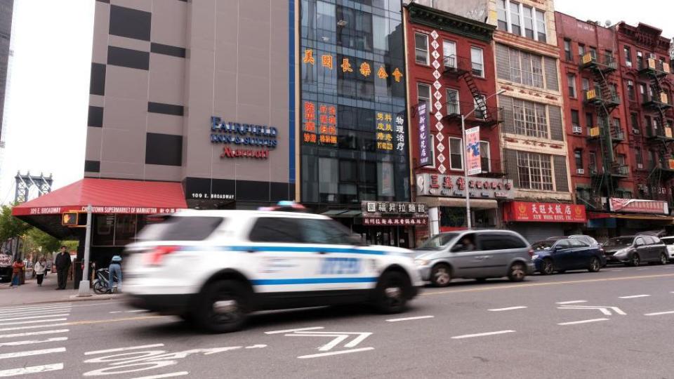 Un auto de policía avanza veloz en una calle de Nueva York