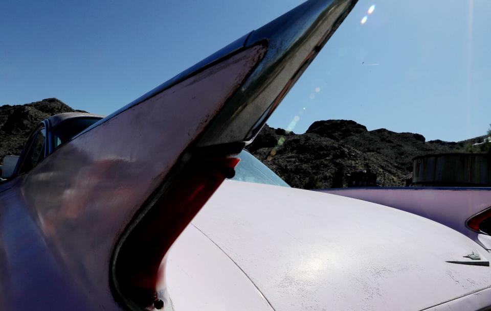 A vintage Cadillac sits by the road at a tourist attraction near the Hoover Dam.