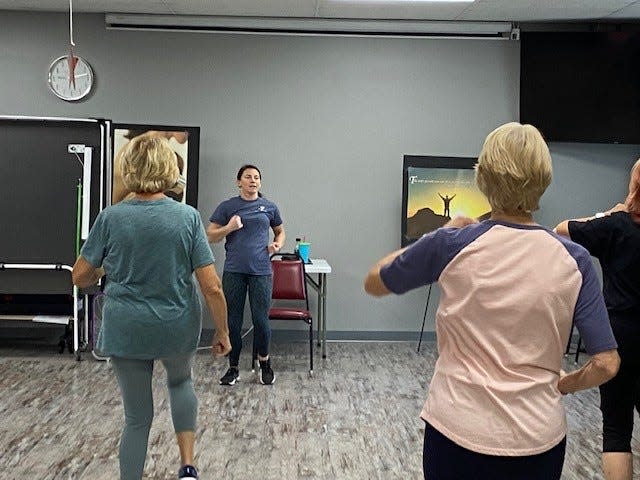 An Enhance Fitness session at Frenchtown Center for Active Adults is shown.