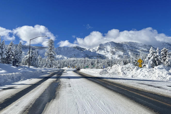 This Sunday, Jan. 1, 2023, photo released by Caltrans District 3, shows Sierra highway back open but chain controls remain in effect as crews clean up in South Lake Tahoe, Calif. California was drying out and digging out on New Year's Day after a powerful storm brought drenching rain or heavy snowfall to much of the state, snarling traffic and closing highways. (Caltrans District 3 via AP file)