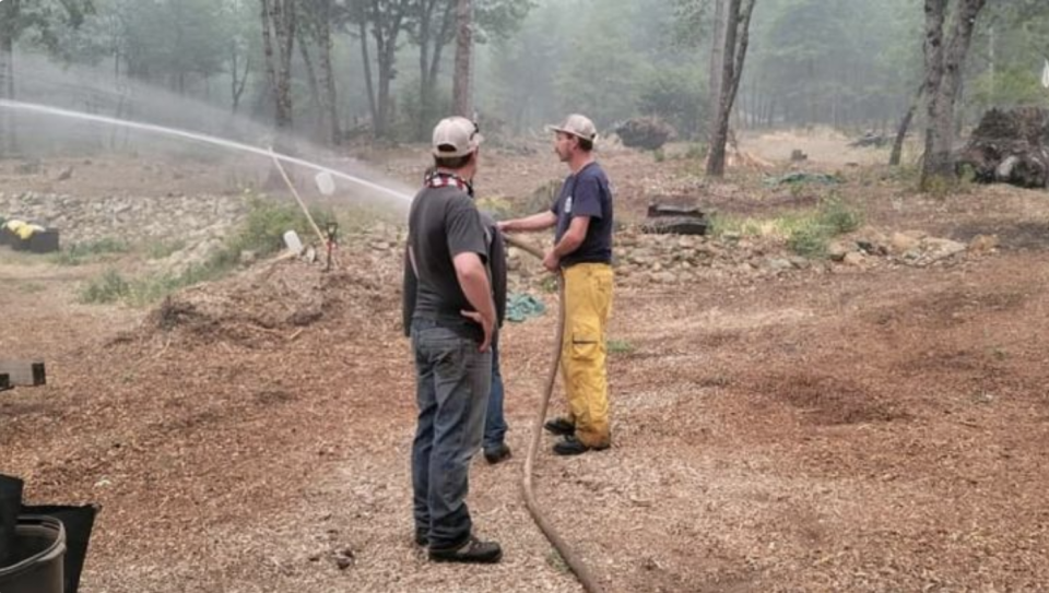 Taylorsville, CA brothers, Cody and Clancy Pearce, with the help of their family member, neighbor, Travis Bloxham, use water tenders to moisturize properties in the event the wildfires affect their homes. (Brad Underwood/GoFundMe)