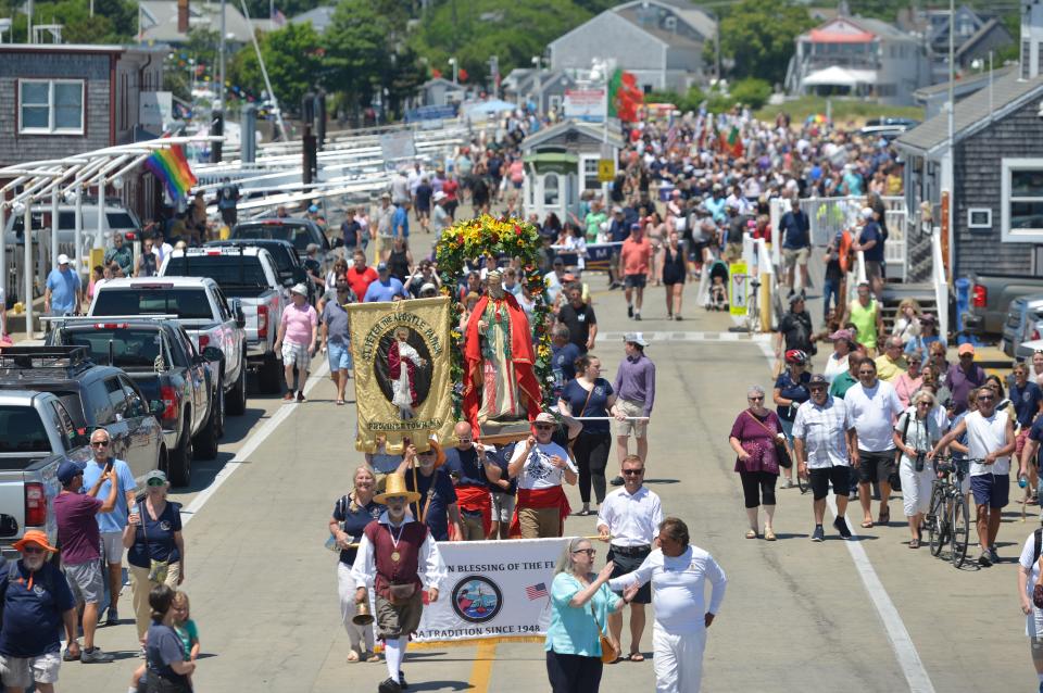 The statue of St. Peter is carried down MacMillan Pier in Provincetown as the procession of fishing families and others follow. The 75th Blessing of the Fleet, part of the 25th anniversary of the Portuguese Festival, was held Sunday. The statue of St. Peter was carried from St. Peter the Apostle Church after a Mass to MacMillan Pier where the blessing was held. To see more photos, go to www.capecodtimes.com/news/photo-galleries. Merrily Cassidy/Cape Cod Times