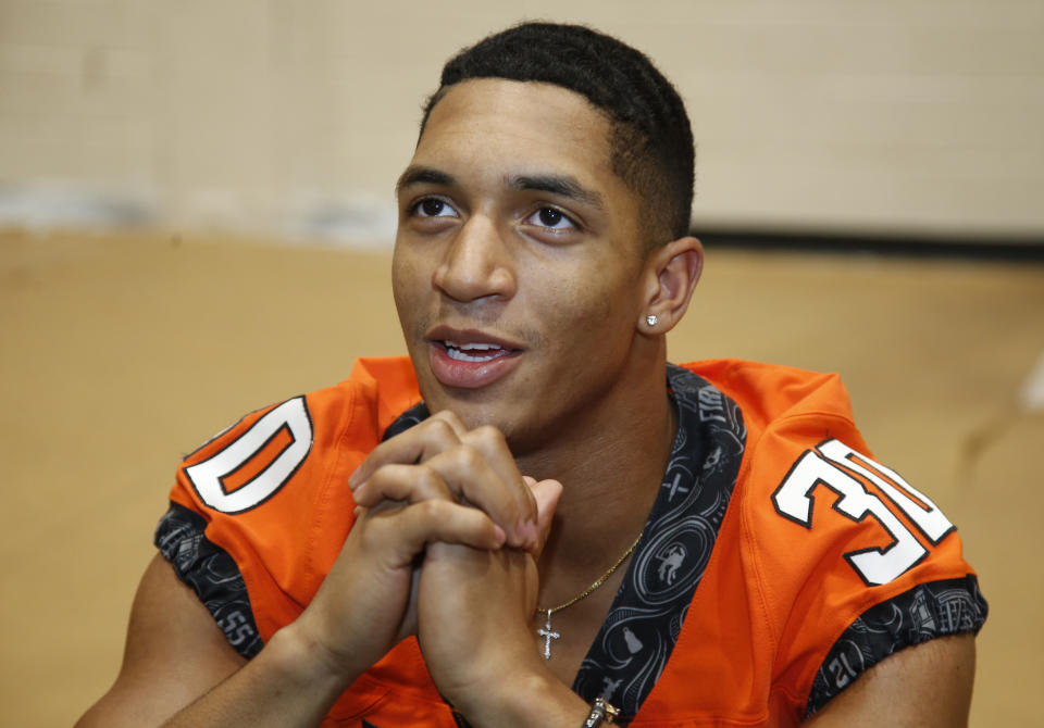 FILE - In this Aug. 4, 2018, file photo, Oklahoma State running back Chuba Hubbard speaks during an NCAA college football media day in Stillwater, Okla. After the Power Five conference commissioners met Sunday, Aug. 9, 2020, to discuss mounting concern about whether a college football season can be played in a pandemic, players took to social media to urge leaders to let them play. to discuss mounting concern about whether a college football season can be played in a pandemic, players took to social media to urge leaders to let them play. (AP Photo/Sue Ogrocki, File)