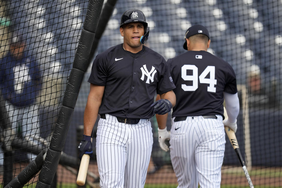 New York Yankees catcher Agustin Ramirez, left, walks out of the batting cage during a baseball spring training workout Thursday, Feb. 15, 2024, in Tampa, Fla. (AP Photo/Charlie Neibergall)