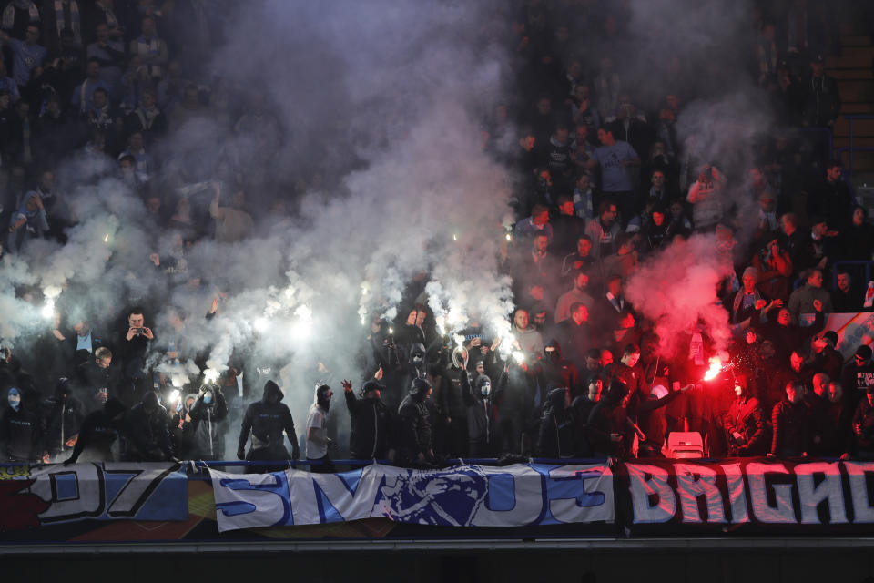 Malmo fans set off flares during the round of 32, second leg, Europa League soccer match between Chelsea and Malmo FF at Stamford Bridge stadium in London, Thursday Feb. 21, 2019. (AP Photo/Frank Augstein)