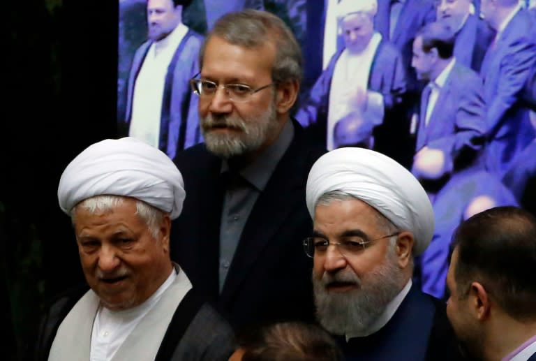 Iranian former president Ayatollah Akbar Hashemi Rafsanjani (L), Parliament Speaker Ali Larijani (C) and President Hasan Rouhani attend the opening session of the new parliament in Tehran