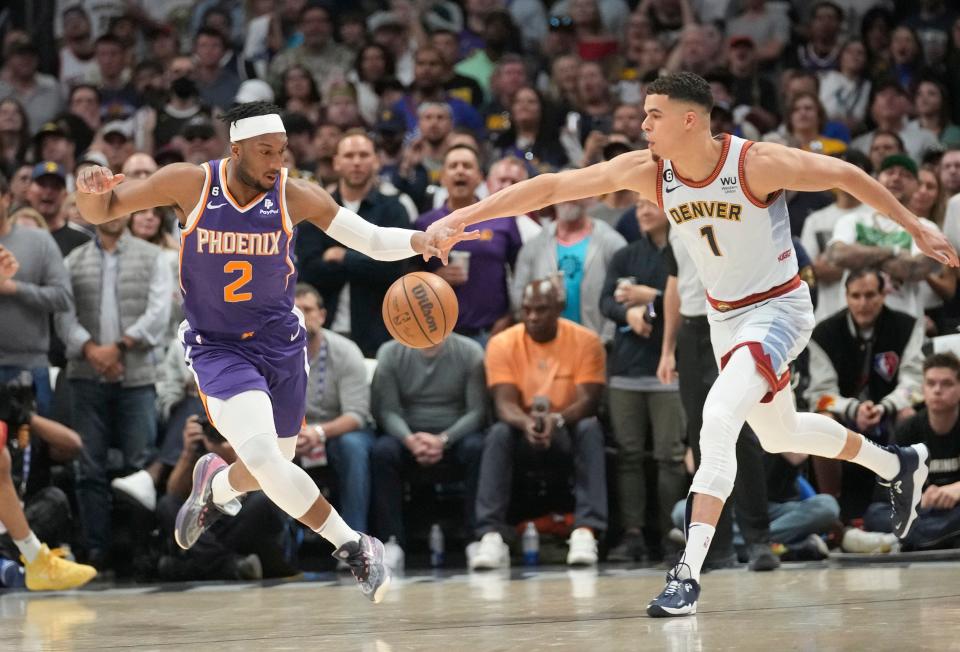 Phoenix Suns forward Josh Okogie (2) steals the ball from Denver Nuggets forward Michael Porter Jr. (1) during the first quarter of the Western Conference semifinals at Ball Arena in Denver on May 9, 2023.