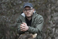 In this Monday, March 30, 2020, photo, Neal Miller poses for a portrait near where he is living during the COVID-19 outbreak in Chicago. Miller said his last stable job was as an adjunct professor at Loyola University in Chicago, sharing a house with four others to save money on rent. Now, all but one of the housemates are now out of work and decided this month to tell their own landlord that they couldn't pay on April 1. (AP Photo/Charles Rex Arbogast)