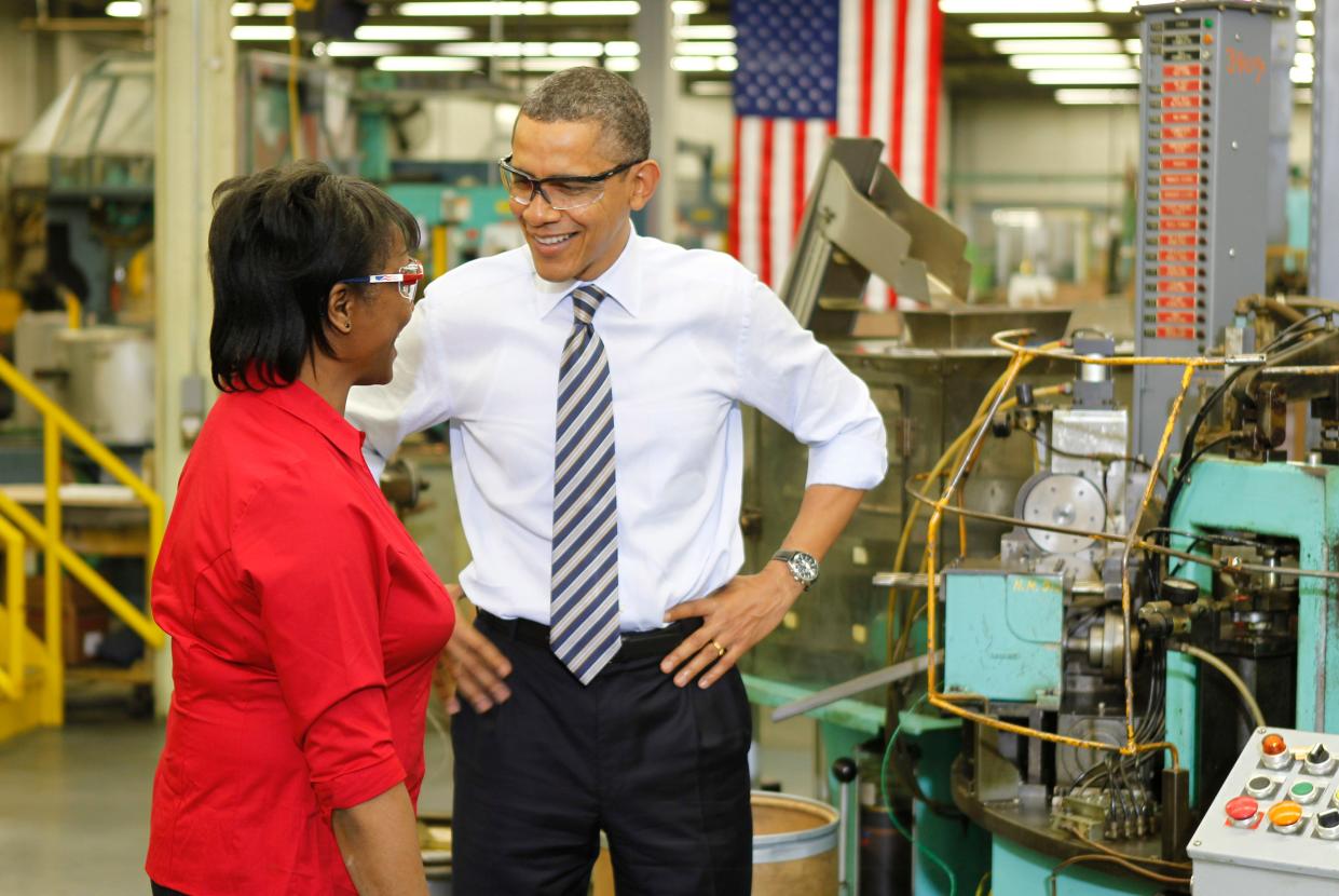 President Barack Obama speaks to Mary Townsend during a tour of Master Lock in Milwaukee on February 15, 2012. Obama promoted manufacturing and highlighted the importance of bringing the jobs back to America
