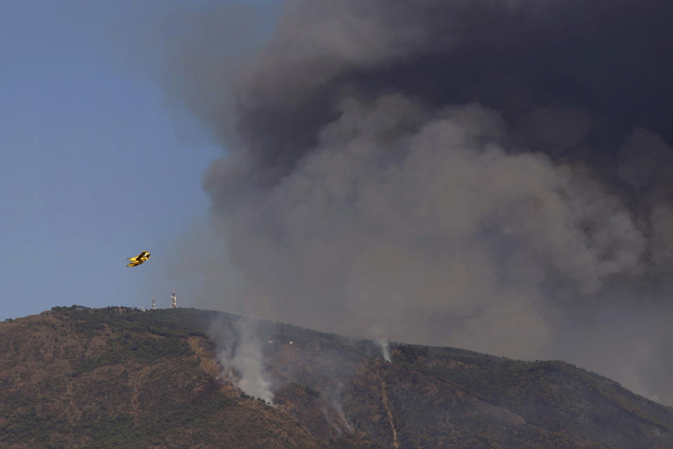 Hydroplanes operate on a wildfire in Estepona, in Malaga province, Spain, Saturday, Sept. 11, 2021. Soldiers were deployed in southeastern Spain Sunday to join the battle against a major wildfire that is burning for a fourth day, invigorated by a stray ember that has sparked a new hotspot. (Álex Zea/Europa Press via AP)