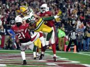 January 16, 2016; Glendale, AZ, USA; Green Bay Packers wide receiver Jeff Janis (83) catches a touchdown pass against Arizona Cardinals cornerback Patrick Peterson (21) and free safety Rashad Johnson (26) during the second half in a NFC Divisional round playoff game at University of Phoenix Stadium. Mandatory Credit: Kyle Terada-USA TODAY Sports