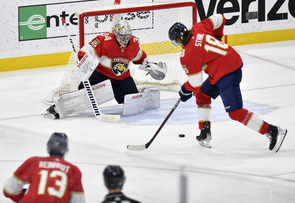 Florida Panthers defenseman Marc Staal (18) keeps the puck away from goaltender Alex Lyon (34) during the second period of an NHL hockey game against the Buffalo Sabres, Tuesday, April 4, 2023, in Sunrise, Fla. (AP Photo/Michael Laughlin)