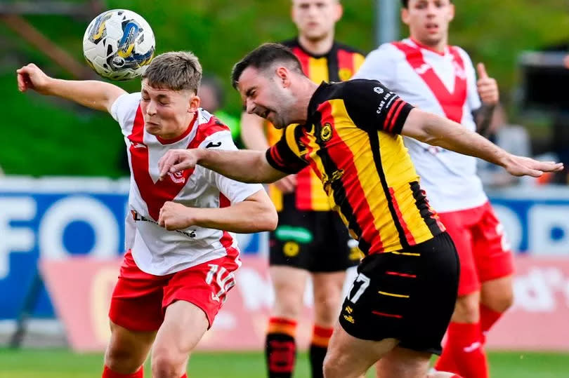 Airdrie's Dean McMaster and Thistle's Scott Robinson battle for possession